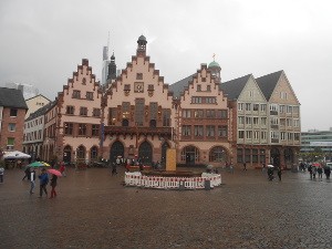The square is nearly deserted in the rain, but five restored old buildings face one side of the downtown city square.